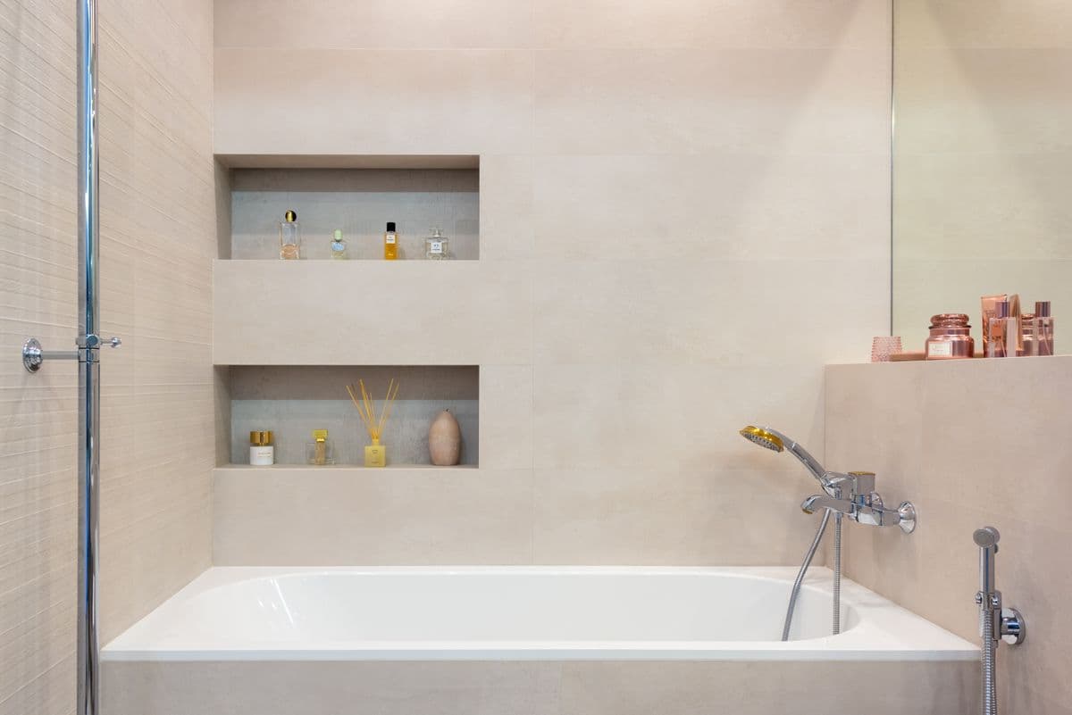 Children's bathroom with a tile tub surround and built-in niche shelving