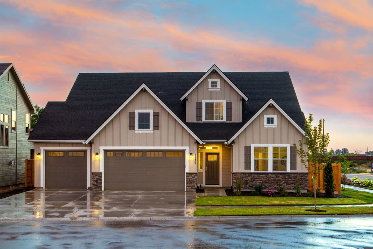 Home with new smooth stucco finish and upgraded garage doors