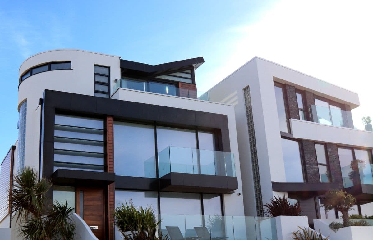 Contemporary two-story home exterior with glass balcony railings
