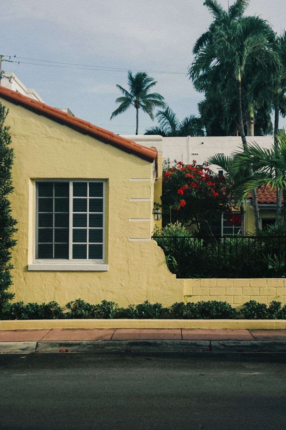 Yellow Spanish-style home exterior with fresh paint and a barrel tile roof