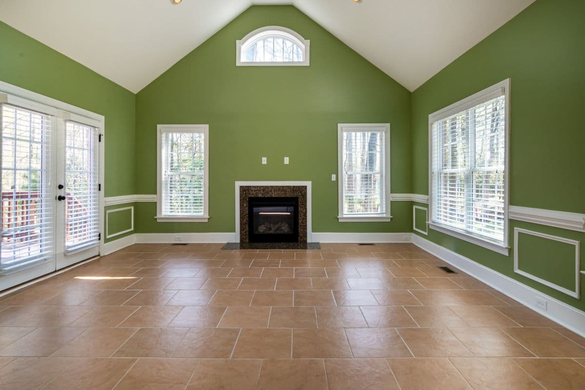 New tile flooring installed in a vaulted family room with a fireplace