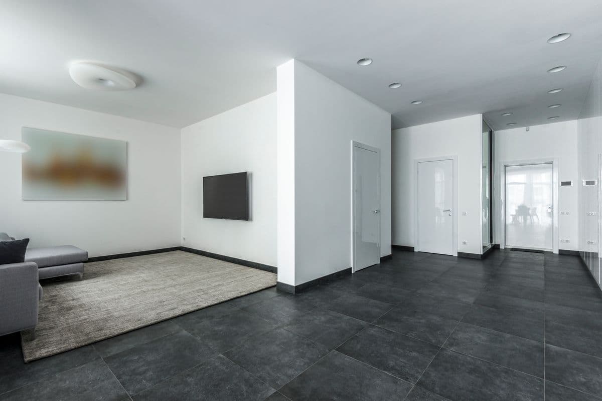Dark large-format tile flowing through an open-plan living space
