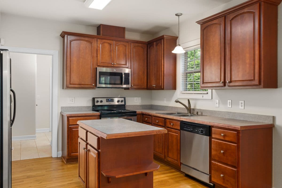 Traditional kitchen with cherry cabinets, laminate counters, and a center island