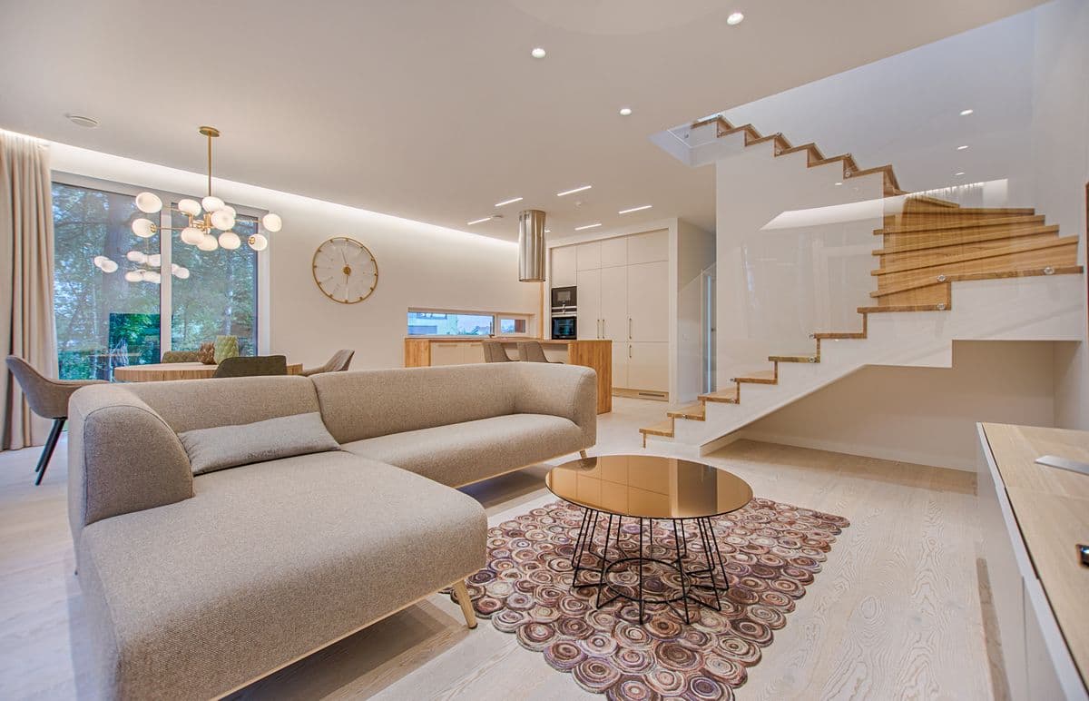 Bright open-plan living and dining room with light hardwood floors