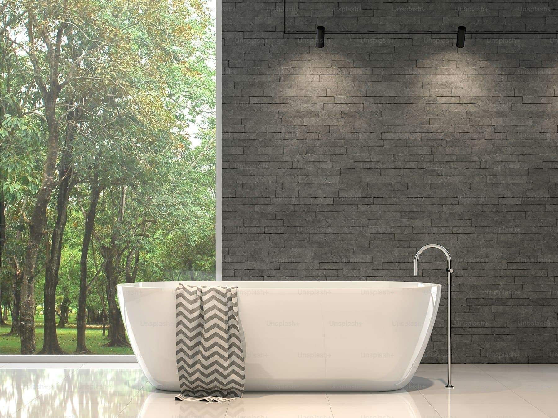Primary bathroom with a freestanding tub and large-format tile