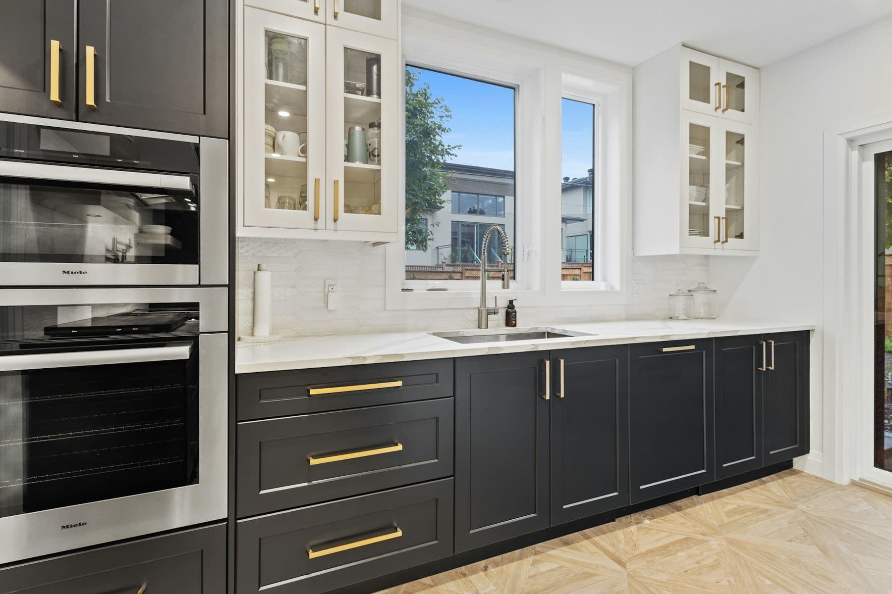 Contemporary kitchen with flat-panel cabinetry and integrated appliances